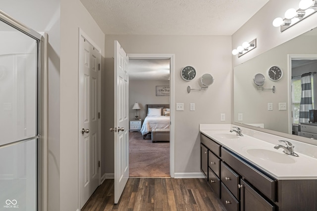 918 Cass Dr, Franklin, IN 46131 - ensuite bathroom featuring wood finished floors, double vanity, a textured ceiling, and baseboards
