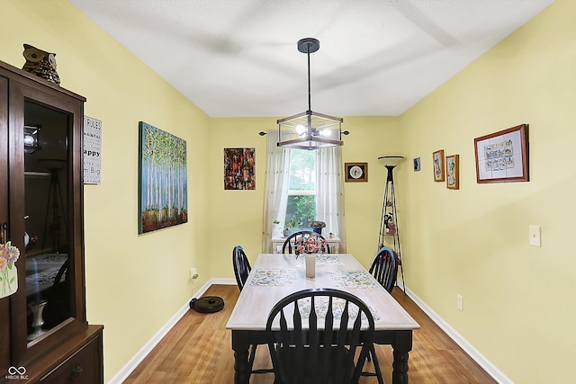 2623 Senators Way, Indianapolis, IN 46217 - dining area with wood finished floors, baseboards, and a chandelier