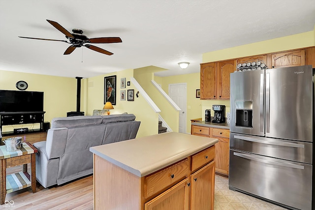 2623 Senators Way, Indianapolis, IN 46217 - kitchen featuring stainless steel refrigerator with ice dispenser, a ceiling fan, a center island, light countertops, and open floor plan