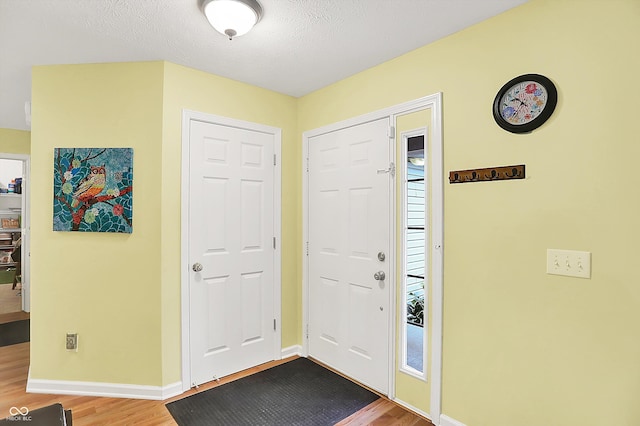 2623 Senators Way, Indianapolis, IN 46217 - entryway with wood finished floors, baseboards, and a textured ceiling