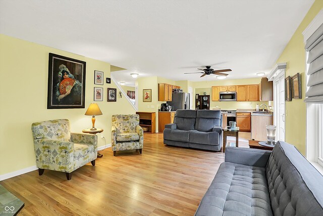 2623 Senators Way, Indianapolis, IN 46217 - living area with light wood-style floors, ceiling fan, and baseboards