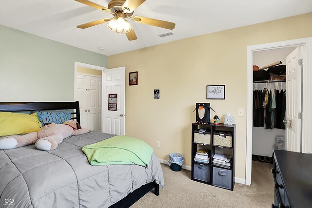 2623 Senators Way, Indianapolis, IN 46217 - carpeted bedroom with a closet, baseboards, a walk in closet, and a ceiling fan