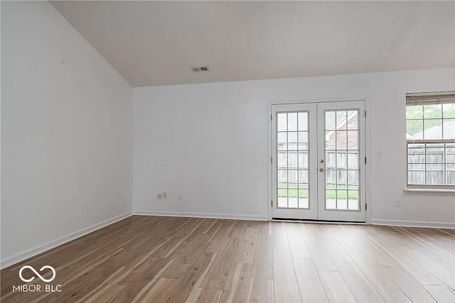 6707 Dovir Woods Dr, Sellersburg, IN 47172 - empty room with light wood-style flooring, french doors, vaulted ceiling, and baseboards