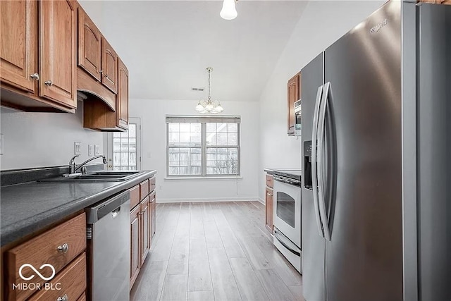 6707 Dovir Woods Dr, Sellersburg, IN 47172 - kitchen featuring stainless steel appliances, brown cabinetry, a sink, a chandelier, and lofted ceiling
