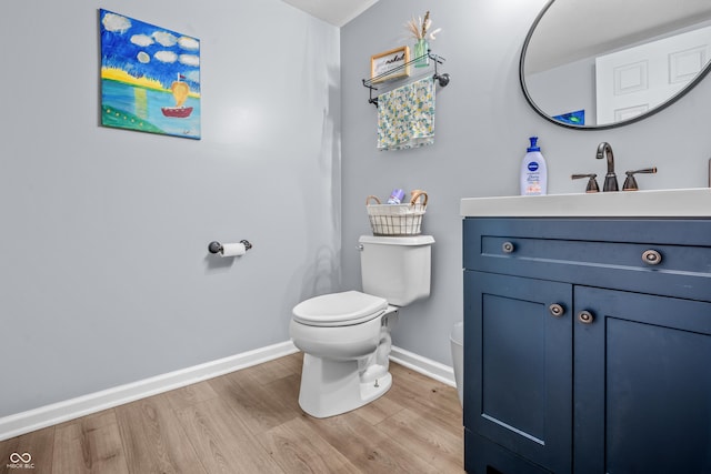 2730 Foxbriar Pl, Indianapolis, IN 46203 - bathroom featuring toilet, baseboards, wood finished floors, and vanity