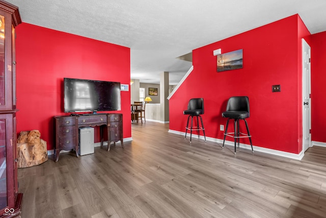 2730 Foxbriar Pl, Indianapolis, IN 46203 - living area featuring wood finished floors, baseboards, and an accent wall