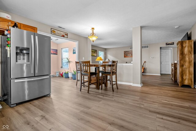2730 Foxbriar Pl, Indianapolis, IN 46203 - dining area with light wood-type flooring and baseboards