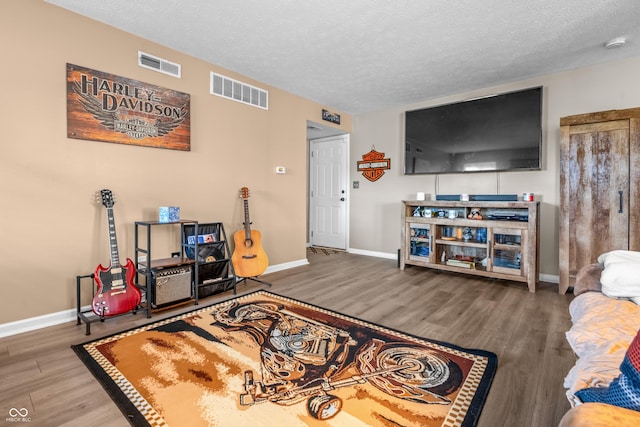 2730 Foxbriar Pl, Indianapolis, IN 46203 - living room featuring wood finished floors, a textured ceiling, and baseboards