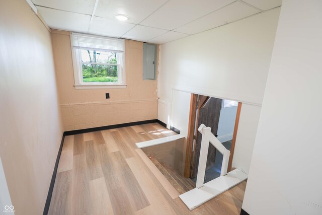 2721 W 34th St, Anderson, IN 46011 - empty room with electric panel, wood finished floors, a drop ceiling, and baseboards