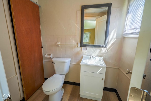 2721 W 34th St, Anderson, IN 46011 - bathroom featuring vanity, toilet, wood finished floors, healthy amount of natural light, and tile walls