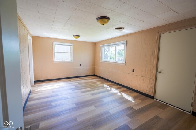 2721 W 34th St, Anderson, IN 46011 - empty room with healthy amount of natural light and wood finished floors