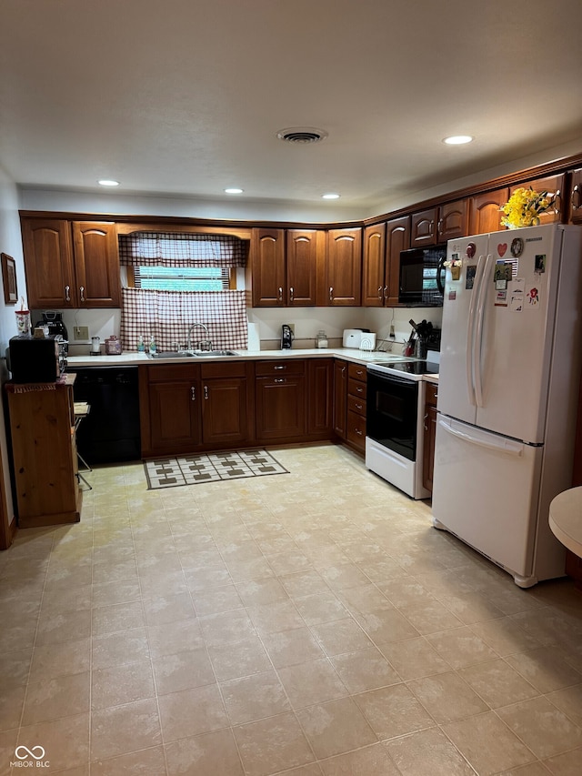 1711 Lafayette Ave Unit 7, Lebanon, IN 46052 - kitchen featuring black appliances, a sink, recessed lighting, light countertops, and backsplash