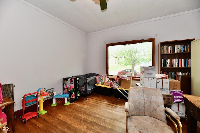 1106 W 4th St, Anderson, IN 46016 - playroom with crown molding, wood finished floors, and ceiling fan