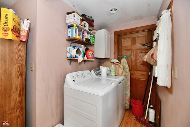 1106 W 4th St, Anderson, IN 46016 - washroom with washing machine and dryer, cabinet space, and light wood-style floors