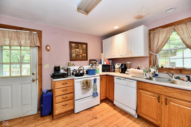 1106 W 4th St, Anderson, IN 46016 - kitchen featuring white appliances, a sink, light wood-style floors, and light countertops