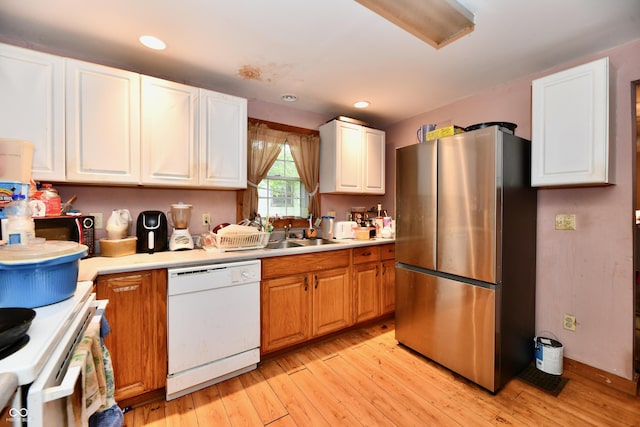 1106 W 4th St, Anderson, IN 46016 - kitchen with freestanding refrigerator, dishwasher, light wood-type flooring, light countertops, and a sink