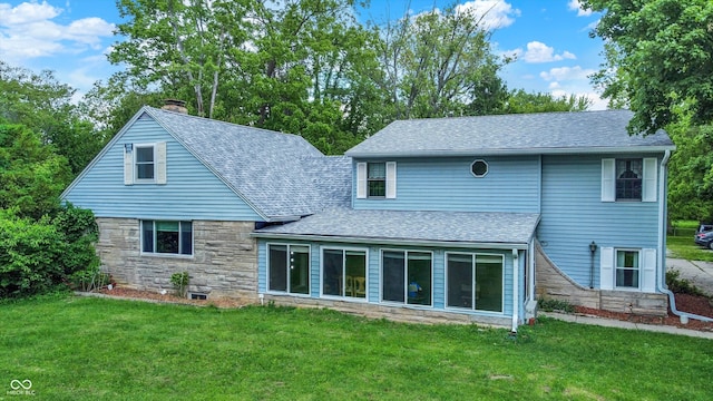 6430 E Southport Rd, Indianapolis, IN 46237 - back of house featuring roof with shingles, a lawn, stone siding, and a chimney