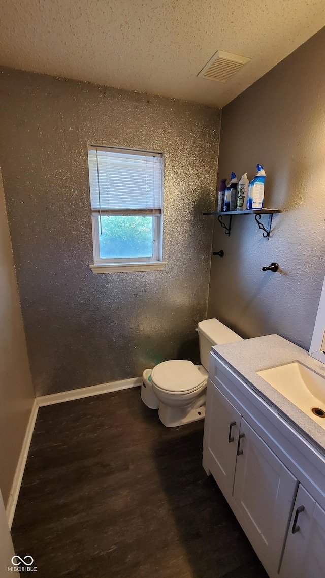6637 Larkwood Ct, Indianapolis, IN 46241 - bathroom featuring wood finished floors, vanity, toilet, and baseboards