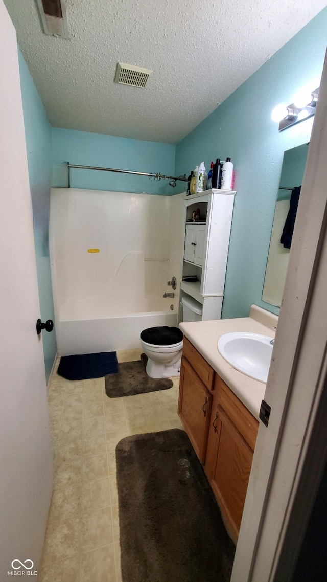 6637 Larkwood Ct, Indianapolis, IN 46241 - full bath with vanity, shower / washtub combination, a textured ceiling, toilet, and tile patterned flooring