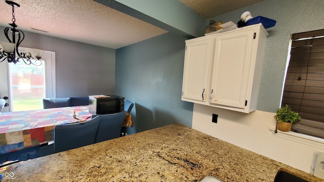 6637 Larkwood Ct, Indianapolis, IN 46241 - dining space with a textured ceiling, a chandelier, and an office area
