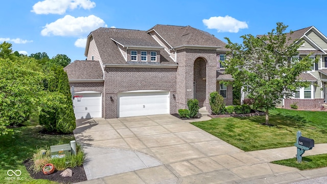 543 Amersham Ct, Avon, IN 46123 - view of front of property featuring concrete driveway, brick siding, a front lawn, and a shingled roof
