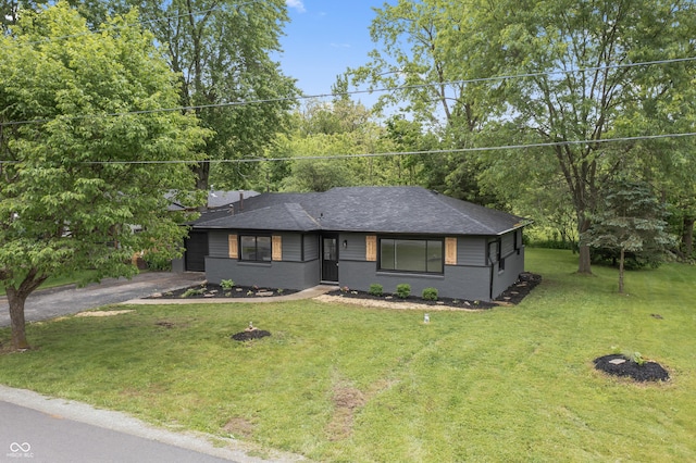 8933 W 1050 S, Fortville, IN 46040 - view of front facade with a front lawn, roof with shingles, and asphalt driveway