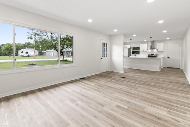 8933 W 1050 S, Fortville, IN 46040 - unfurnished living room with recessed lighting, baseboards, and light wood-style floors