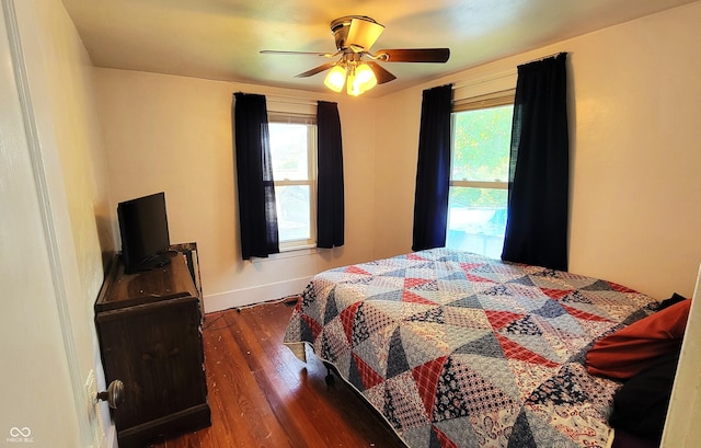 126 W W Blvd, Kokomo, IN 46902 - bedroom featuring multiple windows, wood finished floors, baseboards, and ceiling fan