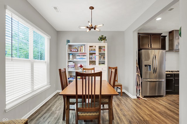 158 Handley St, Indianapolis, IN 46222 - dining area featuring a chandelier, light wood finished floors, and baseboards