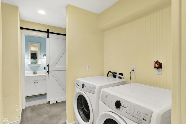 3215 E Edgewood Ave, Indianapolis, IN 46227 - laundry room featuring washer and dryer, a barn door, and light carpet