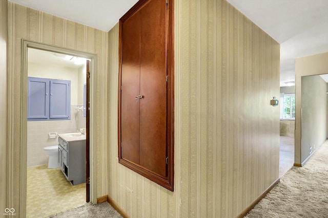 3215 E Edgewood Ave, Indianapolis, IN 46227 - corridor with a sink and light colored carpet