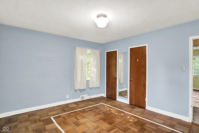 3215 E Edgewood Ave, Indianapolis, IN 46227 - unfurnished bedroom featuring baseboards and multiple windows