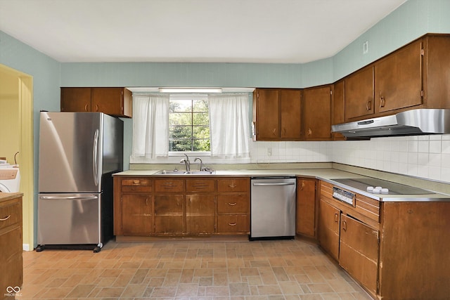 3215 E Edgewood Ave, Indianapolis, IN 46227 - kitchen with appliances with stainless steel finishes, under cabinet range hood, a sink, light countertops, and backsplash