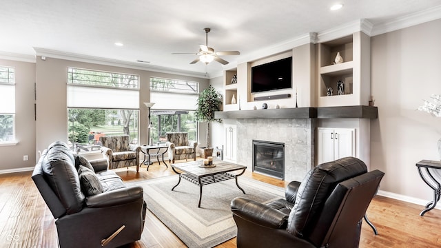 3335 Guilford Ln, Plainfield, IN 46168 - living area featuring crown molding, a tile fireplace, ceiling fan, baseboards, and wood finished floors