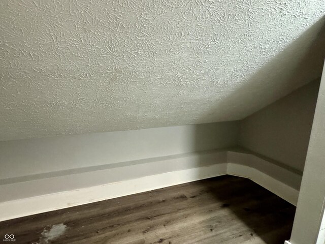4814 E New York St, Indianapolis, IN 46201 - additional living space featuring a textured ceiling and dark wood-style floors