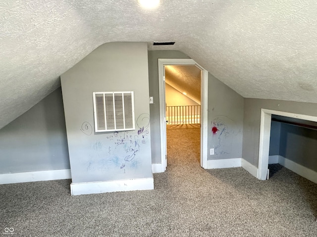 4814 E New York St, Indianapolis, IN 46201 - additional living space featuring a textured ceiling, carpet floors, vaulted ceiling, and baseboards
