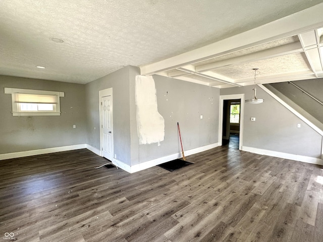 4814 E New York St, Indianapolis, IN 46201 - unfurnished living room with dark wood-style floors, plenty of natural light, a textured ceiling, and baseboards