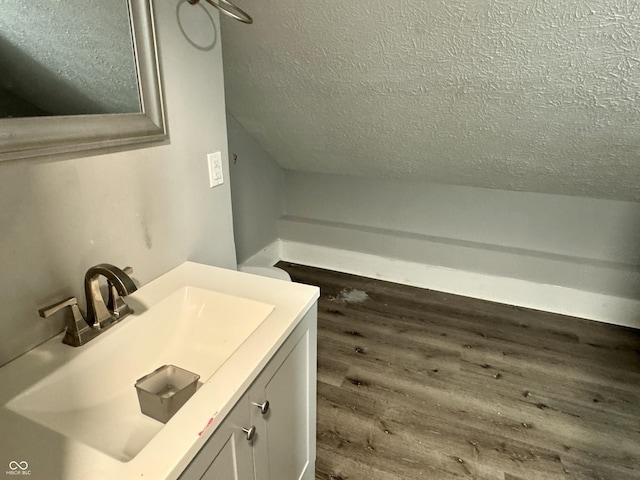 4814 E New York St, Indianapolis, IN 46201 - bathroom featuring a textured ceiling, wood finished floors, and vanity