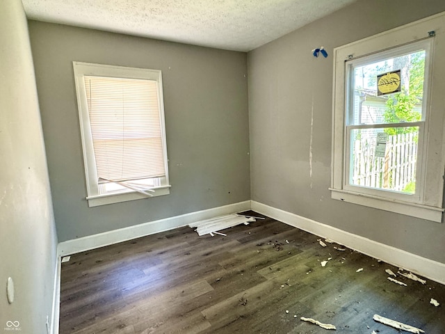 4814 E New York St, Indianapolis, IN 46201 - unfurnished room featuring wood finished floors, a textured ceiling, and baseboards