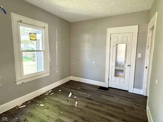 4814 E New York St, Indianapolis, IN 46201 - spare room featuring dark wood finished floors, baseboards, and a textured ceiling