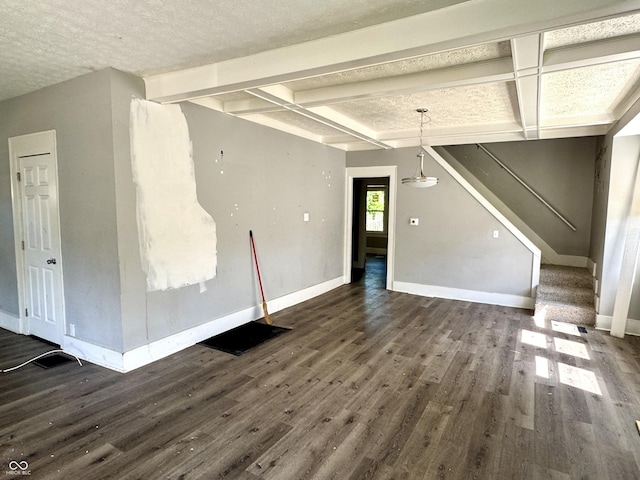 4814 E New York St, Indianapolis, IN 46201 - unfurnished living room with baseboards, dark wood finished floors, beamed ceiling, a textured ceiling, and stairs