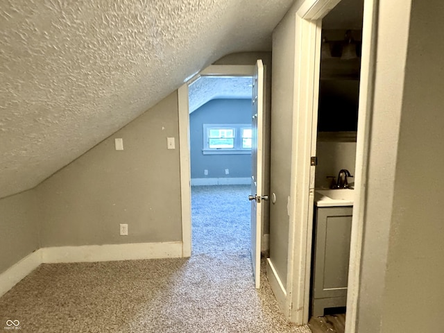 4814 E New York St, Indianapolis, IN 46201 - bonus room with a textured ceiling, vaulted ceiling, carpet, a sink, and baseboards