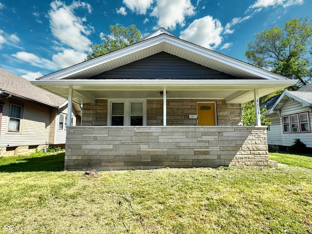 4814 E New York St, Indianapolis, IN 46201 - view of front of property featuring stone siding, a front lawn, and a porch
