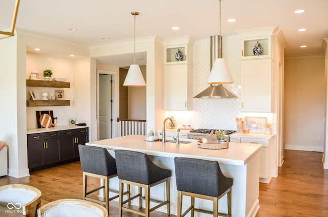 987 Oak Terrace Rd, Westfield, IN 46074 - kitchen with ornamental molding, light countertops, a kitchen breakfast bar, a sink, and tasteful backsplash