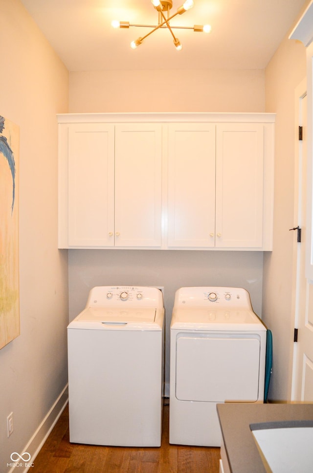 987 Oak Terrace Rd, Westfield, IN 46074 - laundry room featuring washer and dryer, wood finished floors, cabinet space, and baseboards