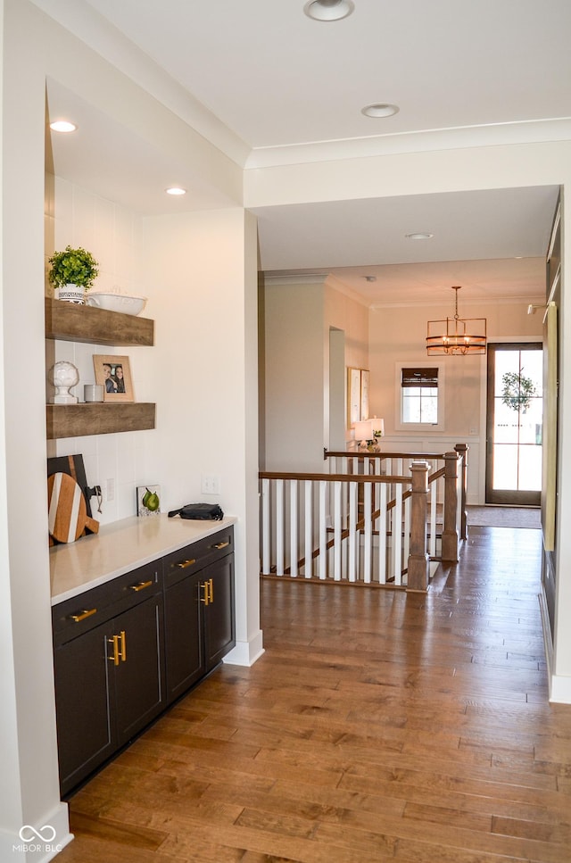 987 Oak Terrace Rd, Westfield, IN 46074 - hallway featuring wood finished floors, a chandelier, an upstairs landing, ornamental molding, and recessed lighting