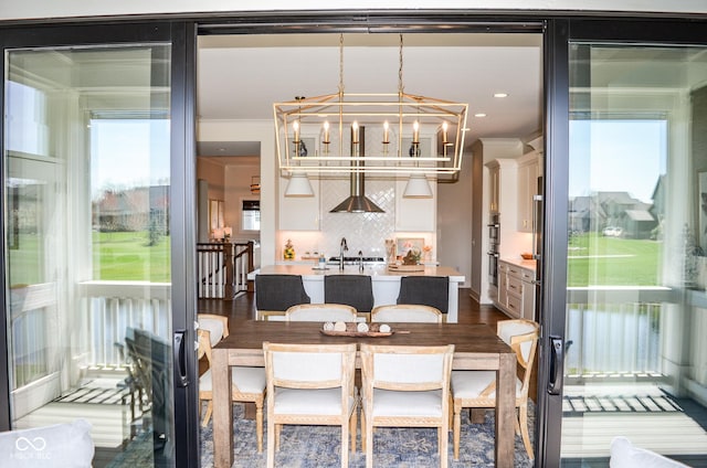 987 Oak Terrace Rd, Westfield, IN 46074 - dining area with a chandelier, ornamental molding, and dark wood-style flooring