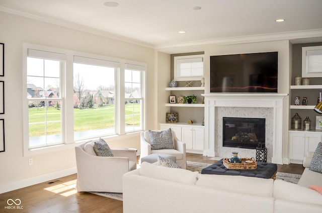 987 Oak Terrace Rd, Westfield, IN 46074 - living area with ornamental molding, wood finished floors, a high end fireplace, baseboards, and built in features