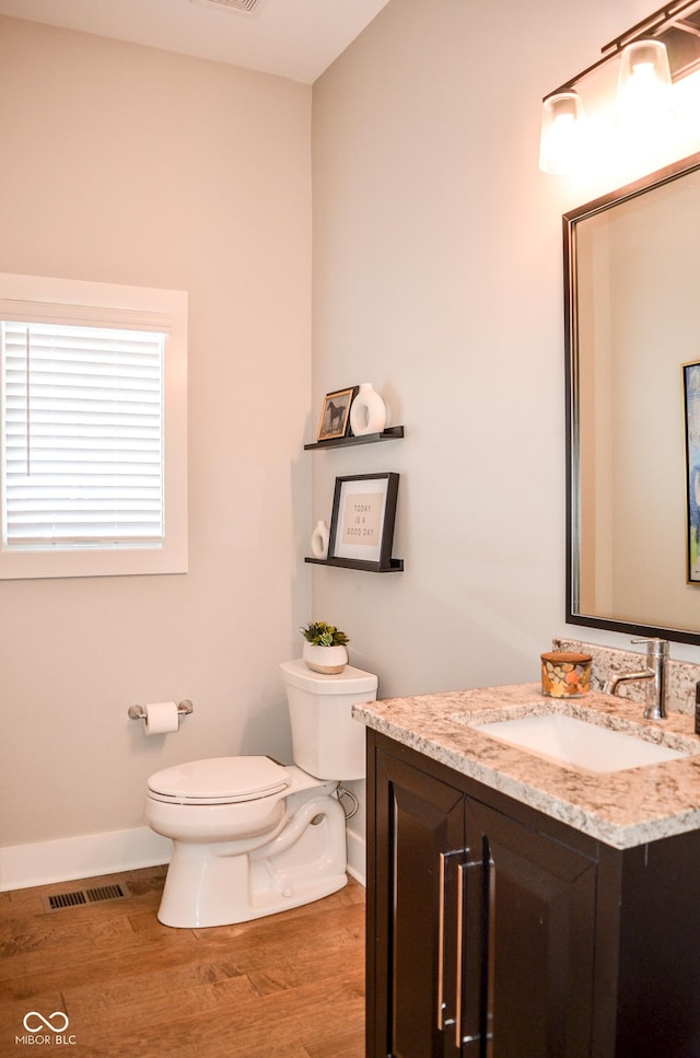 987 Oak Terrace Rd, Westfield, IN 46074 - half bath featuring toilet, vanity, wood finished floors, and baseboards
