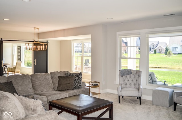 987 Oak Terrace Rd, Westfield, IN 46074 - living area featuring a chandelier, light colored carpet, baseboards, recessed lighting, and a barn door